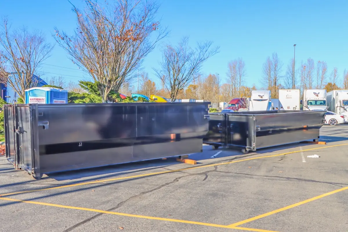 Professional dumpster rental service with roll-off container on residential driveway in Mentor-on-the-Lake